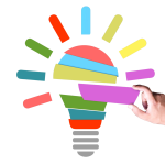 colorful blocks create a light bulb, hand is placing the last piece
