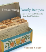Shows an open box filled with hand written recipes. 