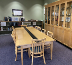 Room with a table and chairs, and shelves with historical documents