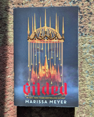 Book cover for Gilded by Marissa Meyer decorated with rhinestones