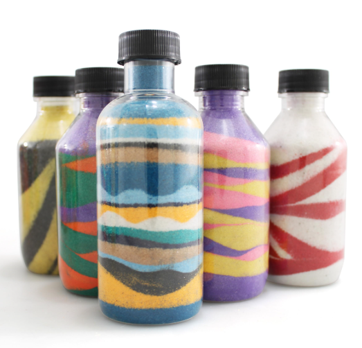 Bottles with colorful sugar in layers