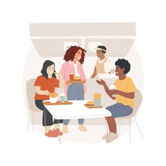 teens having snacks and chatting around a table