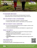 Two women walk together on a trail.