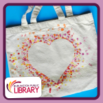 a canvas tote bag with an inverse painted heart design on the side