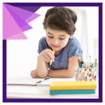 a brown-haired, white child sits at a table looking thoughtfully at a blank piece of paper. he is ho
