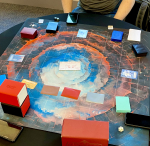 A grid board has cards arrayed across it, in preparation to play Sorcery The Contested Realm