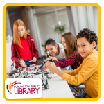 a group of kids work on building small robot cars around a large table