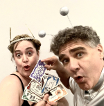 A man and a woman are holding up cards to the camera and making silly faces