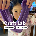 A child peering over stretched purple slime held in two hands.