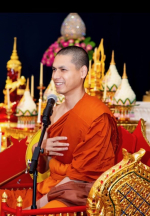 Monk sitting with hand on heart