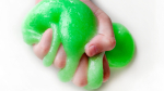 Child holding green slime