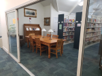 A wooden conference table in the Nonfiction Room.
