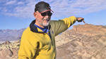 Prof. Little, a white man, points out geology stories at Death Valley National Park.