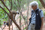 A lemur and a woman smile at each other