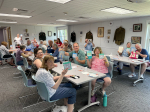people smiling and holding up BINGO cards