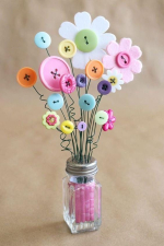 photo of a clear glass salt shaker filled with colored glass chips and with faux flowers made from f