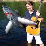 Tom with guitar in the water