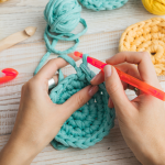 Hands crocheting a circle