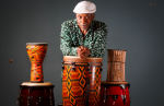 Cornell Coley leaning on a drum.
