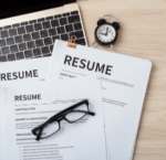 Resumes on a table with a pair of glasses.