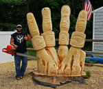 Artist Jesse Green with a large chainsaw sculpture 