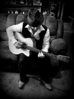 Arthur James playing guitar in black and white