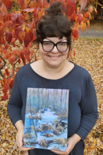 photo of the artist holding artwork