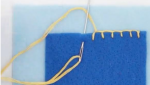 Blanket stitch, yellow thread on blue.