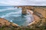 Photo of a rock formation jutting out of the ocean and a beach in Australia. Photo taken by Mike Dye