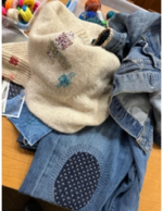 Jeans and sweater with visible mending 