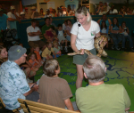 Presenter holding snake for audience to see