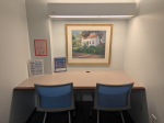 Two desks at a built-in desk are situated in a small room.