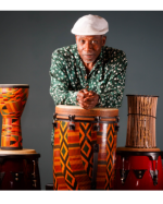 cornell coley sitting among drums.