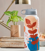 A water bottle with floral and leaf silhouettes, on a neutral background.