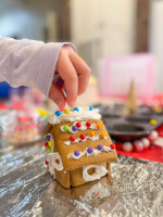 Kids gingerbread house with icing and candy.