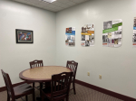 A study room with a table and four chairs.
