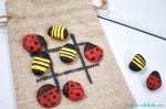 Bug tic tac toe with painted rocks.