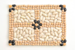 A mosaic made of different colors of dried beans.