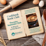 Cookbook with wooden spoon and cookbook cover.