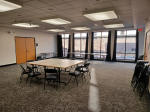 The back section of the Karen E. George conference room, contains tables and chairs