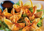 Crab rangoon on a bed of lettuce.