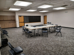 The front section of the Karen E. George conference room, contains tables and chairs
