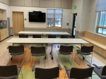 classroom with long desks and 12 chairs.