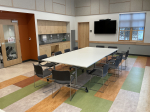 classroom with one large conference table and 12 chairs.