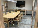 Conference room with seating for 8 at one table.