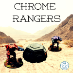 Two robot mech suits stand in a desert scene with a large bunker between them, ready to fight. 