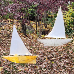 Two paper lanterns shaped like boats.