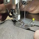 A close-up of a sewing machine in use.