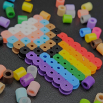 A close-up of a Pride flag made out of heat-fusible beads.
