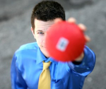 Bryson Lang holding an out of focus red ball.
